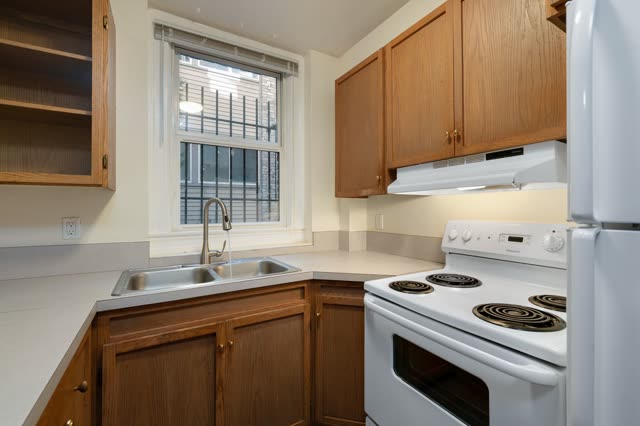 Kitchen with wood cabinets, sink and stove